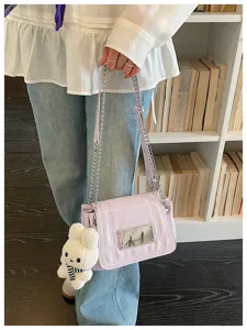 Light purple crossbody bag with chain strap and cute bunny plush pendant for daily commute.