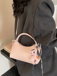 Pink PU leather shoulder bag for women, trendy crescent handbag with cute horse charm and strap.