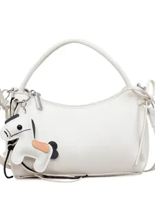 Minimalist white hobo shoulder bag for women with cute horse charm and bow side details.