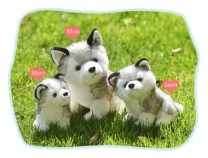Detail view of cute simulated husky plush toy on grass, soft stuffed puppy doll for gifts.