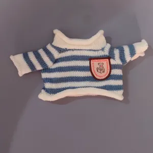 Blue and white striped knit sweater detail for small bear doll, cozy turtleneck design.