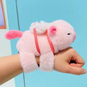 Cute pink capybara plush slap bracelet toy with pull string tail for wrist wear.