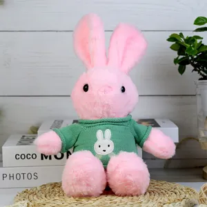 Cute pink plush rabbit toy wearing green knitted sweater, soft stuffed animal gift for kids.