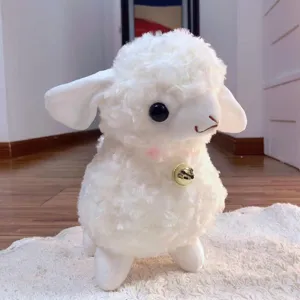 Cute white plush lamb toy detail, soft fluffy material with a small golden bell, perfect gift.