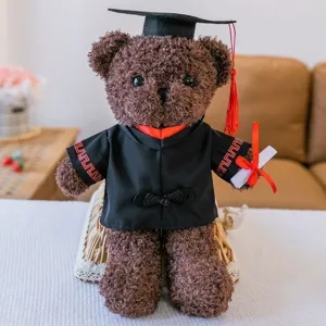 Brown teddy bear plush toy wearing black graduation cap and gown, ideal for graduation gift.
