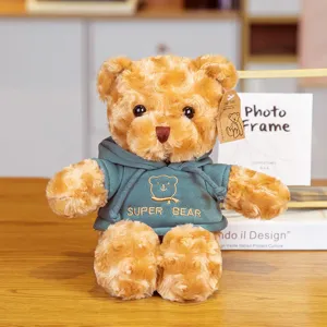 Detailed view of a cute brown plush teddy bear wearing a stylish dark green hooded sweatshirt.