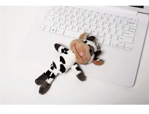 Cute cow plush toy keychain detail shot showing soft fabric texture and adorable tongue expression.