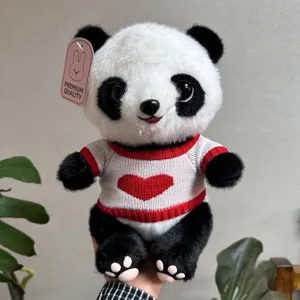Cute panda plush toy detail showing soft fur texture and lovely red heart knit sweater.