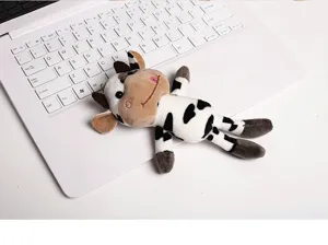 Cute cow plush toy detail view, soft stuffed animal bag pendant and keychain for girls gift.