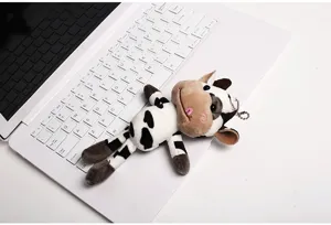 Adorable plush cow keychain and bag charm featuring soft fabric, cute expression, and detailed stitching.