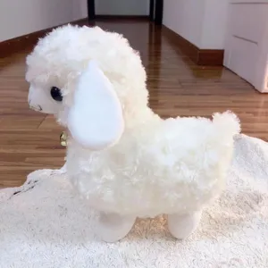 Close-up detail shot of a cute white plush lamb toy with a small golden bell for claw machine.
