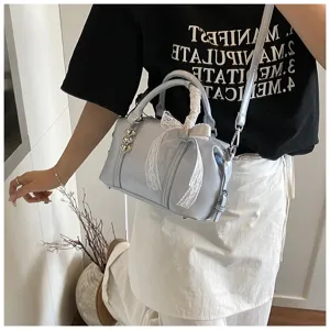 Light blue fashion pillow shoulder bag with white lace bow and heart charms for women.