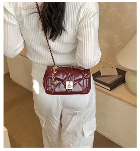 Burgundy quilted chain shoulder bag, stylish crossbody handbag with gold hardware.