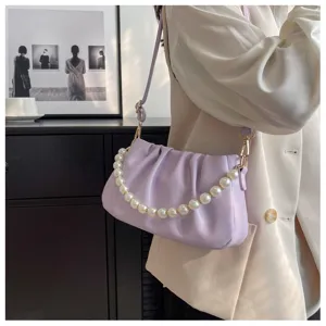 Close-up detail shot of an elegant light purple ruched shoulder bag with a pearl chain strap.