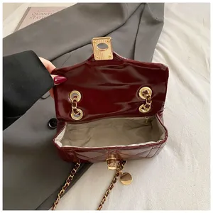 Detail view of burgundy quilted chain bag interior structure and premium golden hardware.