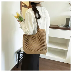 Close-up of the casual woven straw tote bag, showing its large capacity and vacation style.