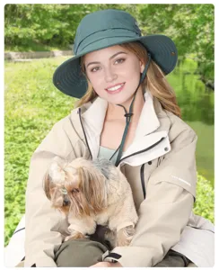 Outdoor sun protection bucket hat detail shot, worn by model in park, breathable design.