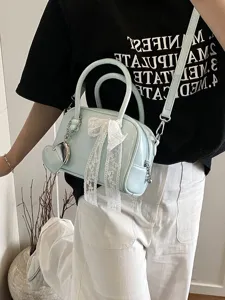 Light blue patent leather bowling bag with cute lace bow and heart pendant for women.