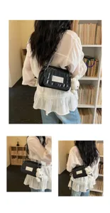 Black patent leather shoulder bag detail, metal chain strap and cute plush bunny pendant.