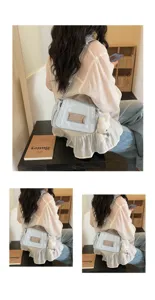 Detailed view of the light blue glossy chain shoulder bag with a cute plush bear charm.