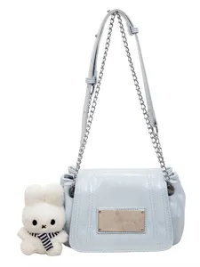 Chic light blue women shoulder crossbody bag with chain strap and cute plush rabbit pendant.