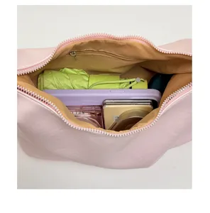 Pink dumpling shoulder bag interior detail showing large capacity, storage space, zip closure.
