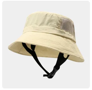 Detailed view of beige outdoor bucket hat with black chin strap and breathable side mesh panel.