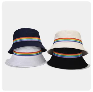 Detail view of fashionable cotton bucket hats featuring colorful rainbow woven ribbon stripes.