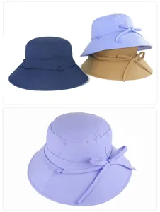 Wide brim sun hat detail view, featuring cute bow tie, perfect for summer sun protection.