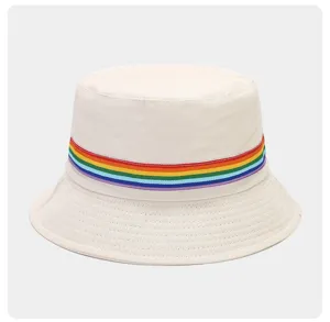 Close-up detail of white cotton bucket hat featuring colorful rainbow striped ribbon.