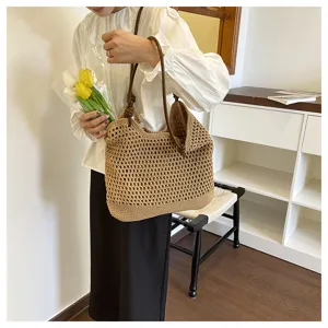 Detailed view of the casual woven tote bag featuring crochet pattern and leather handles.