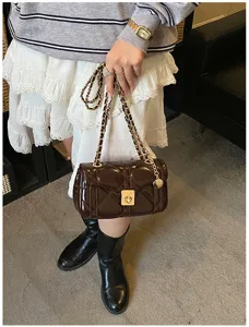 Chic quilted patent leather chain shoulder bag for women, elegant cross-body design.