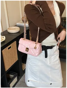 Pink quilted chain shoulder bag detail, elegant design with metal lock and strap for women.