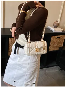 Women's chic white quilted chain shoulder bag, trendy designer style crossbody bag for spring.