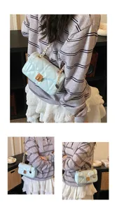 Detailed view of women light blue quilted chain shoulder bag featuring metal lock closure.