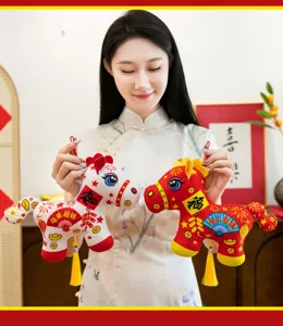 Detailed shot of traditional Chinese New Year plush horse hanging ornaments with auspicious text.