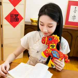 Chinese New Year red plush mascot toy hanging decoration with traditional blessing text and tassel.
