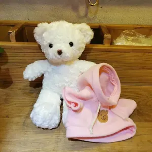 White plush teddy bear toy with cute pink hoodie outfit, soft stuffed animal doll for kids.