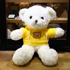 White teddy bear plush toy in yellow hoodie, cute stuffed animal doll for kids claw machine.