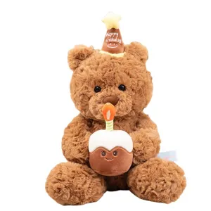 Cute brown plush teddy bear holding birthday cake detail close up view, soft toy gift for kids.