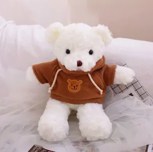 Cute white teddy bear plush toy wearing brown hooded sweatshirt, soft toy detail presentation.