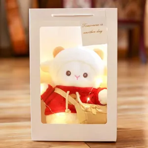 Cute white sheep plush toy in gift box with red sweater, perfect birthday gift for girls.