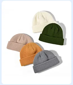 Close-up of thick knit beanie hats in multi colors, showing soft ribbed texture and warm design.