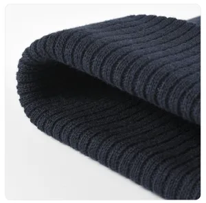 Close-up view of dark blue ribbed knit fabric texture, soft and warm winter cap detail.
