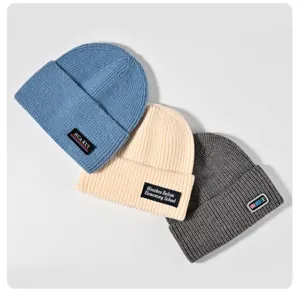Custom embroidered knit beanie for cold winter weather, cozy warm wool hat detail view.