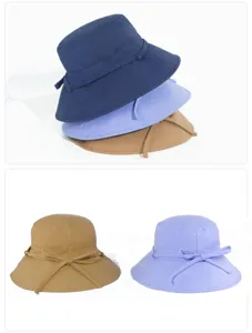 Detailed view of the wide-brim bucket hat featuring a back bow tie, multi-color display.