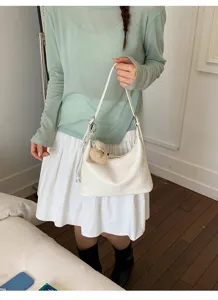 Women casual solid color white shoulder bag hobo dumpling bag with cute plush pendant.