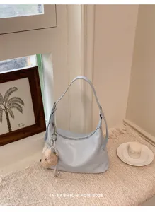 Light blue leather shoulder bag for women, stylish casual hobo dumpling bag with cute bear charm.
