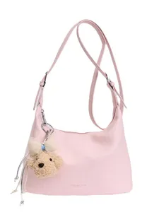 Stylish pink leather shoulder bag for women, casual crossbody purse with cute bear pendant.