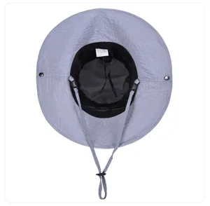 Detail view of grey sun hat showing inner mesh lining, adjustable chin strap, and size tag.